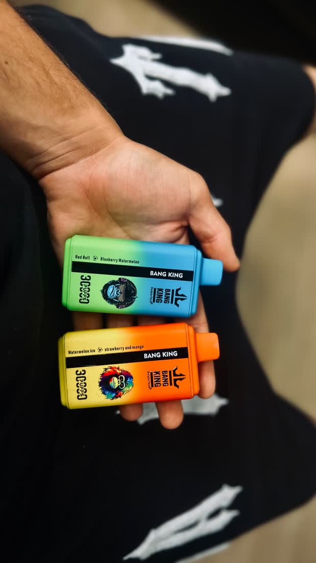 Two Bang King devices held in one hand, showing the colourways
