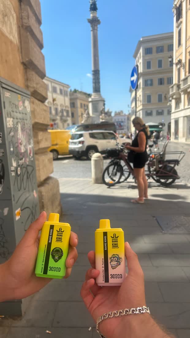 Two devices held up on a city street